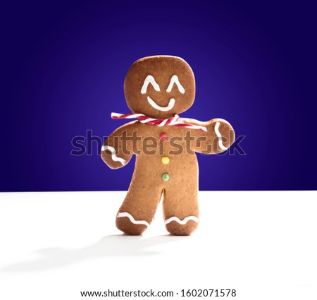 Cookie man on dark blue background and white backdrop. Christmas concepts