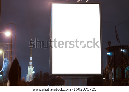 Vertical advertising billboard urban. city format in the night city. Luminous advertising field Mockup. landmark in the background
