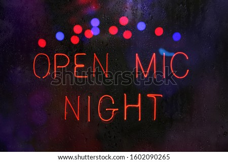 Open Mic Night Sign in Rainy Window