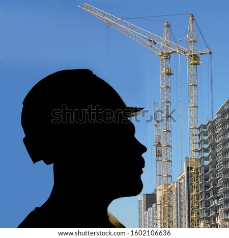 photo silhouette of Working Man in yellow Hard Hat, Man wear helmet on high buildings background. 