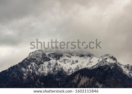 gorgeous dramatic mountain snowy peak winter time foggy cloudy sky picturesque landscape nature wallpaper background concept picture with empty copy space for your text or inscription 