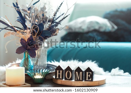 Still life in blue tones, with wooden inscription home and decorative elements, in the living room .