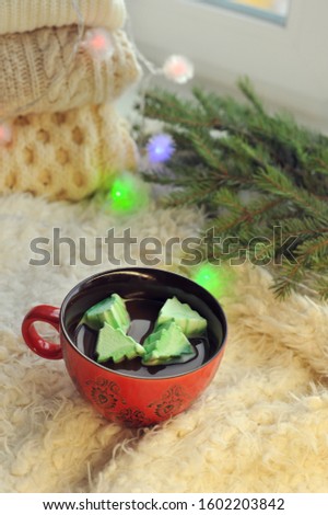 Big red cup with hot chocolate and marshmallows in the shape of Christmas trees. Winter concept with place for your text.
