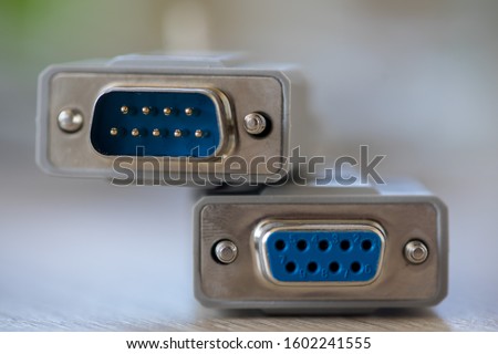 Close-up of a RS-232 serial port. Female to male extension cord on a wooden table. Royalty-Free Stock Photo #1602241555