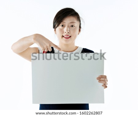 Young asian woman showing blank board isolated on white background.