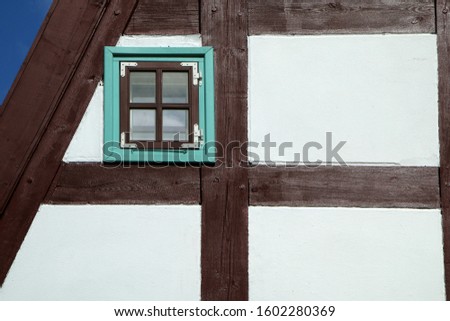 A picture of the historical brick family house in Klaipeda in Lithuania. The detail of the half-timbered frontage. 