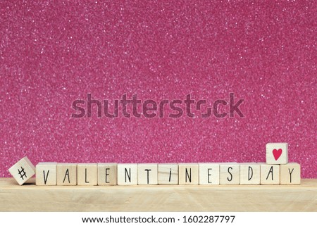 Wooden cubes with hashtag and the word valentine's day, social media concept background close-up