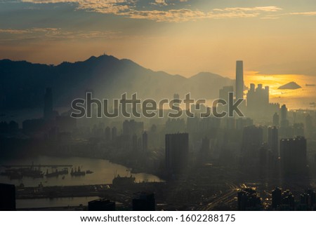 Silhouette of Hong Kong cityscape under sunbeam