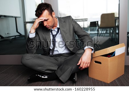 Sad fired businessman sitting outside meeting room after being dismissed Royalty-Free Stock Photo #160228955