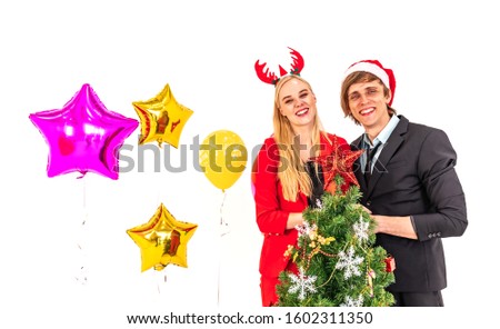 young happiness couple enjoy posing with colorful balloons and christmas tree in new year celebration party and isolated on white background