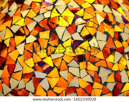 Abstract background of irregular shape multicolored pattern glass. Selective focus and vintage style. Design and decorative elements.