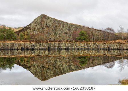 A section through the Whin Sill at Cawfields, Northumberland, England on the line of Hadrian's Wall. Royalty-Free Stock Photo #1602330187