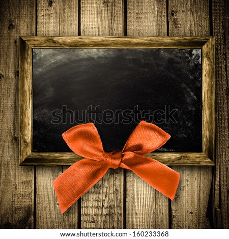 Wooden frame with a red bow