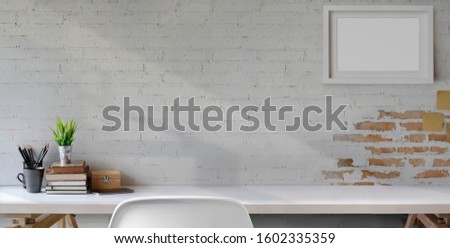 Top view of comfortable vintage workplace with office supplies and copy space on white table and brick wall background