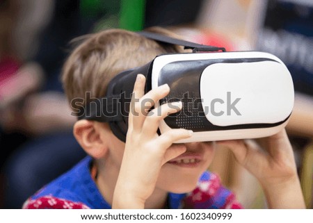Child in virtual glasses. The boy in 3D glasses.