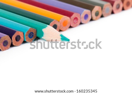 Colorful pencils, green pencil standing out, isolated on white background.