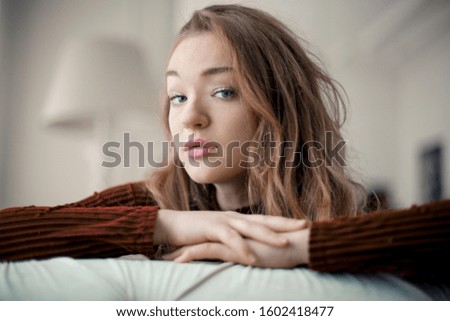 Beautiful young woman relaxing at home.