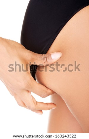 Femal buttock. She's checking fat or cellulitis. Isolated on white.