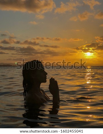 Girl silhouette in the sunset on the beach