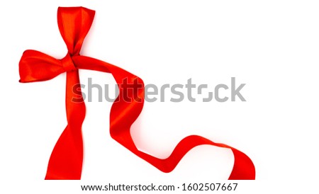 Red ribbon on a white background. Lots of empty space.