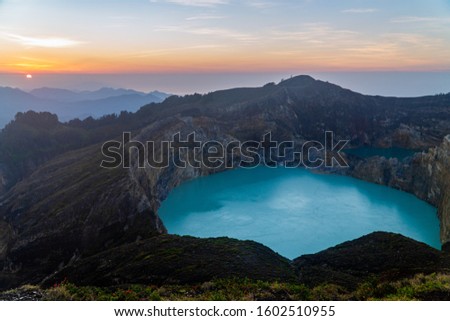 Sunrise at Mount Kelimutu with tricolor volcano lake, aerial view