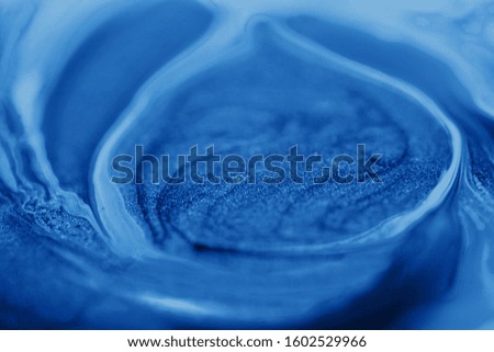 Beautiful abstract bright blue background with streaks and stains. Copy space