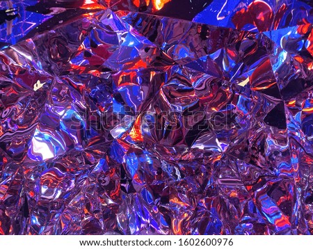 Colorful free forms and lines reflected on surface of metal sheets. This id blur photography.