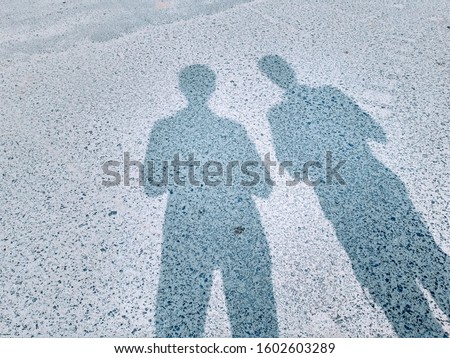 Shadow of two person on a sunny day