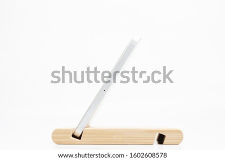 wooden smartphone stand on white background