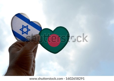 Hand holds a heart Shape Israel and Bangladesh flag, love between two countries