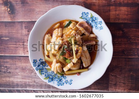 Sweet and sour squid for food menu photos in a restaurant with wooden background pictures taken from above
