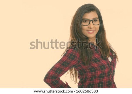 Close up of young happy Persian woman smiling with eyeglasses isolated against white background