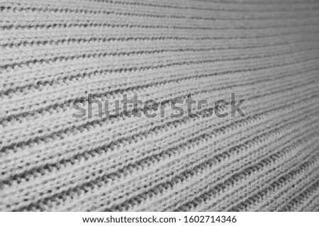 A photo with a close-up shot of ivory-colored fabric.  The weave of the fabric looks in detail.