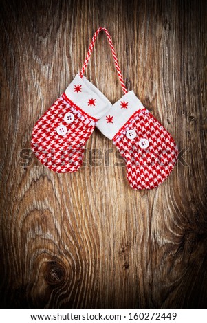 Christmas mittens on wooden background