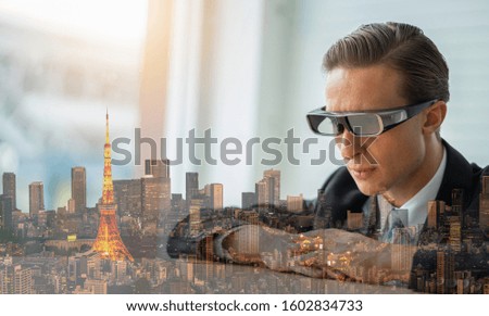  Male architects wear virtual reality glasses, work with 3D models of the city, use virtual reality modeling software applications.
