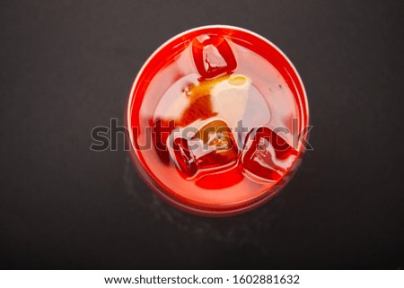 red refreshing drink with ice top view