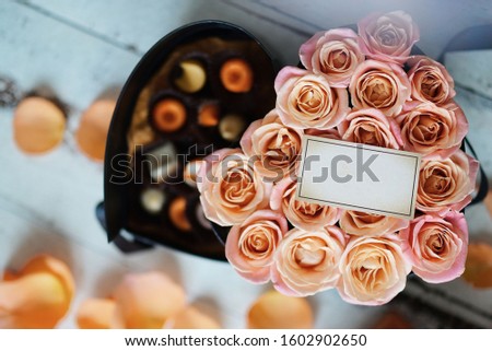 Business card on roses and candies