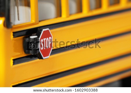Yellow school bus, focus on stop sign. Transport for students