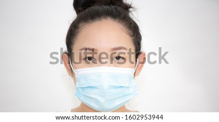 Close-up face of a young Asian woman wearing a mask to prevent germs, toxic fumes, and dust. Prevention of bacterial infection Corona virus or Covid 19 the air in a white background
