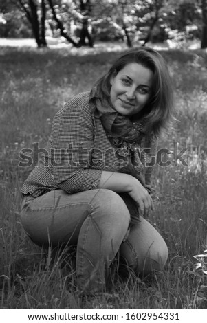black and white photo of a girl on a background of nature