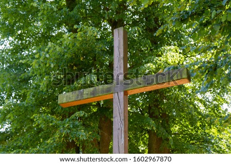 An old wooden cross in a park in the Sanctuary of Our Lady of Tylicz. Shot in 2019. Royalty-Free Stock Photo #1602967870