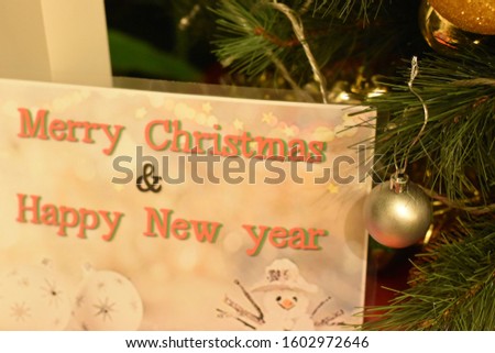 Merry Christmas Card near Christmas Tree
