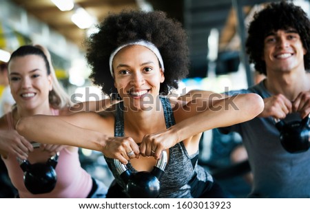 Picture of cheerful fit fitness team in gym