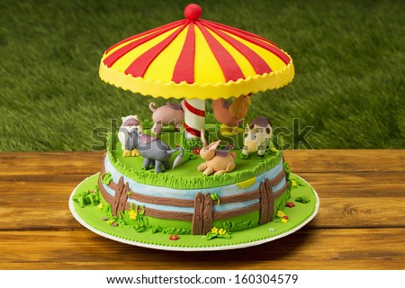 Farm themed cake on picnic table on grass background/Fondant farm themed cake