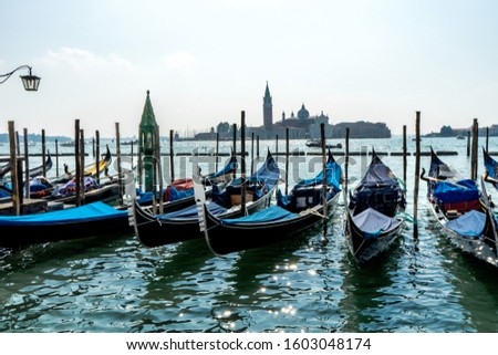 Gondolas at the Piazza San Marco in Venice, Italy. The island of Giudecca in the background.