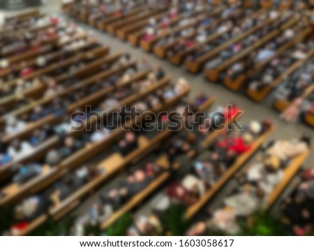 Abstract blur of church members in pews from above inside sanctuary. Royalty-Free Stock Photo #1603058617