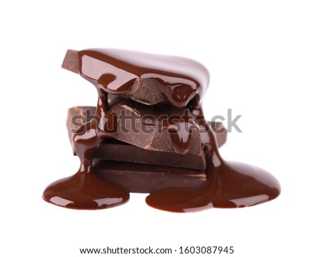 Chocolate pieces stack and chocolate syrup isolated on white background. Close up. Royalty-Free Stock Photo #1603087945