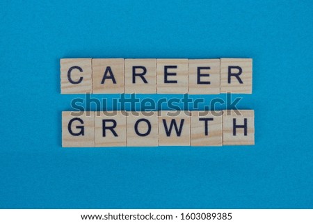 phrase career growth made from gray wooden letters lies on a blue green background