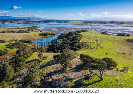 Aerial View of Elkhorn Slough, Moss Landing, California. Elkhorn Slough is a 7-mile-long tidal slough and estuary on Monterey Bay in Monterey County, California. Hiking, bird watching, kayaking.  Royalty-Free Stock Photo #1603101823