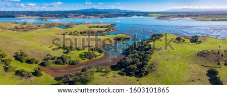 Aerial Panoramic View of Elkhorn Slough, Moss Landing, California. Elkhorn Slough is a 7-mile-long tidal slough and estuary on Monterey Bay in Monterey County, California.  Royalty-Free Stock Photo #1603101865